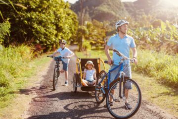Family of father and kids biking at tropical settings